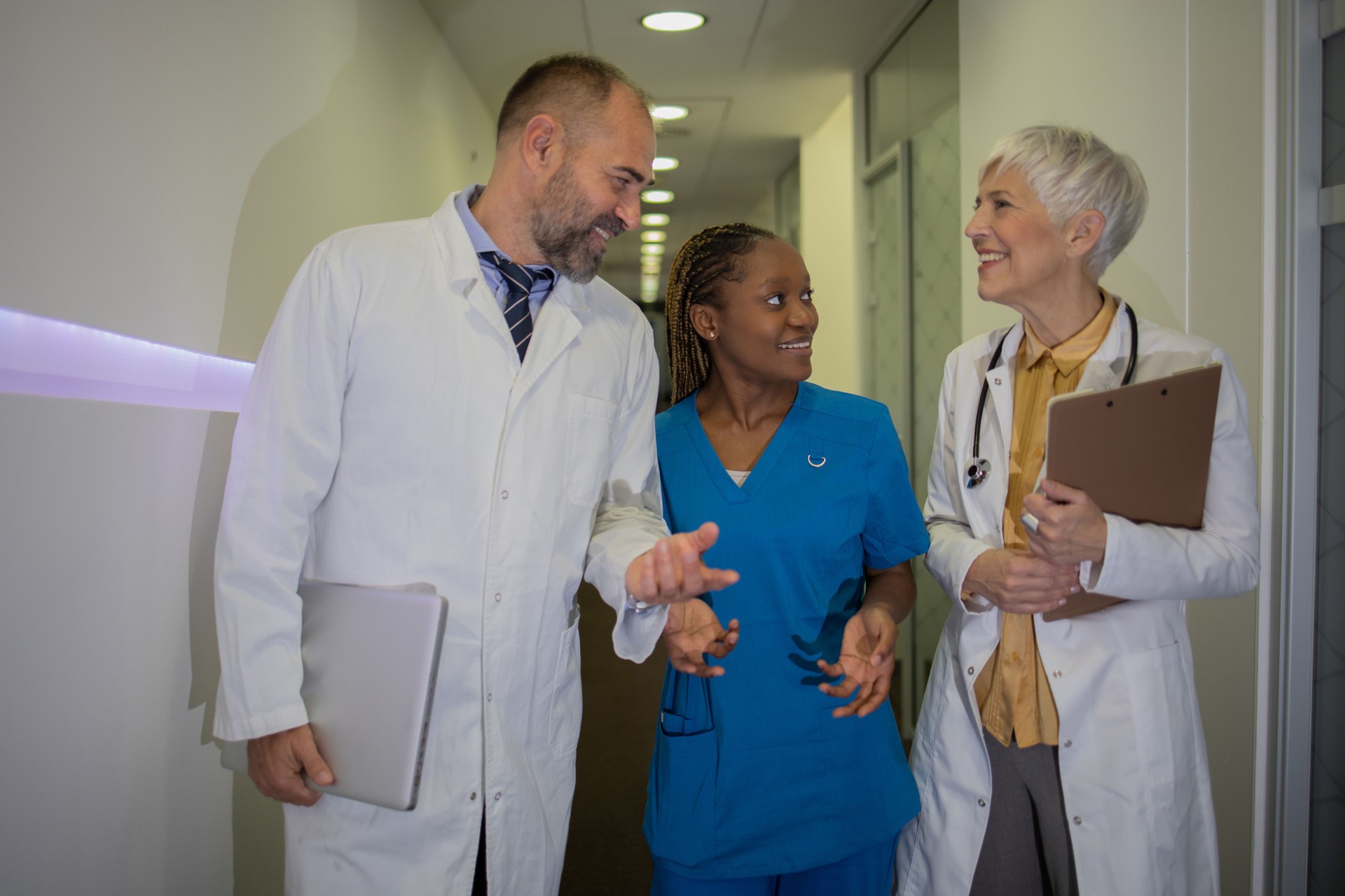 Doctor and nurse discussing patient case at hospital