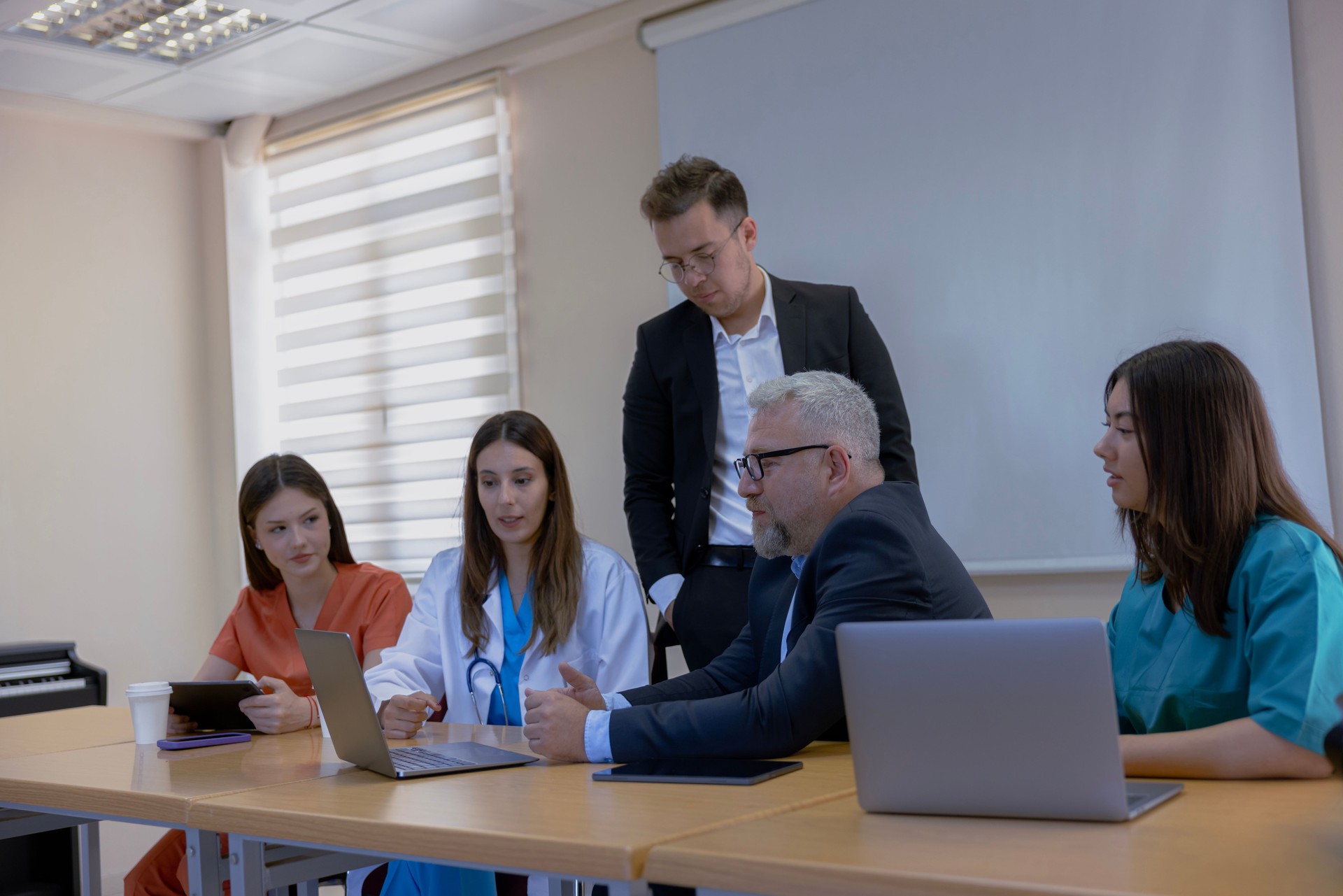 Group of Medical Team and Business People Meeting in Hospital and Office