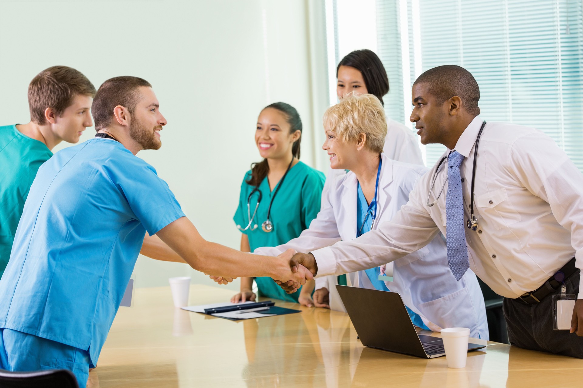 Hospital staff interviewing potential employees in board room